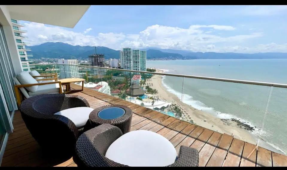 a balcony with a view of a beach and the ocean at Icon Vallarta in Puerto Vallarta