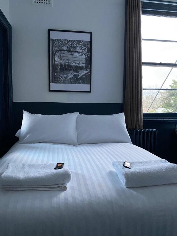 a bedroom with a bed with two towels on it at Royal Hotel Oberon in Oberon