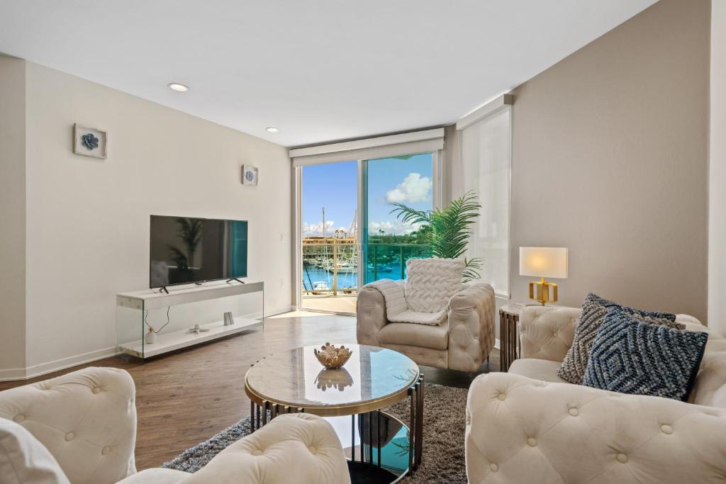 a living room with a couch and a table at Venice Marina Water Front Luxury Condo in Los Angeles