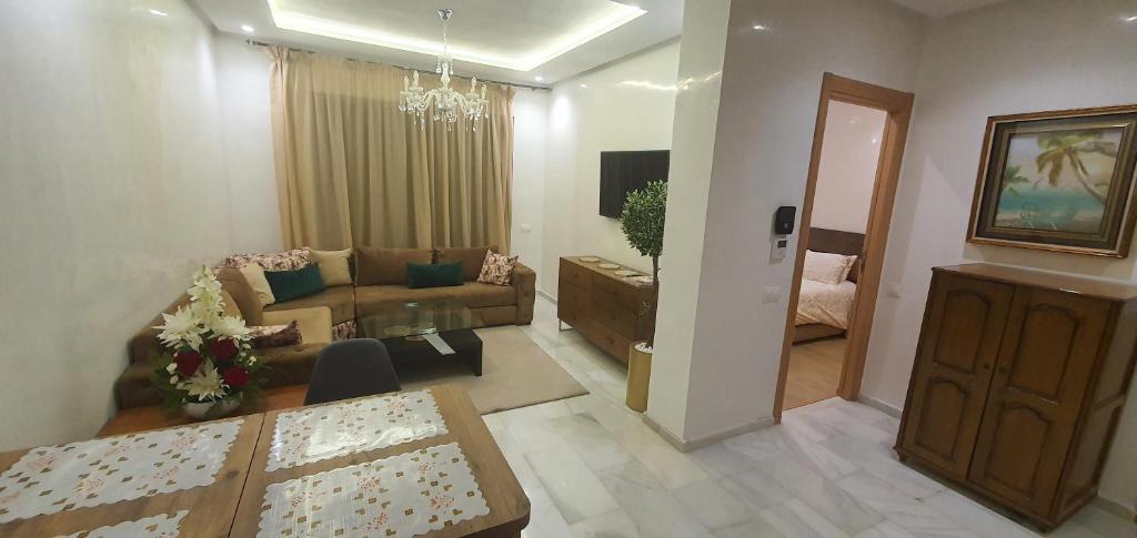 a living room with a couch and a table at Aerostay Jamal in Dah Hammou Ben Cheïkh