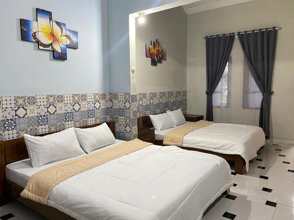 Postel nebo postele na pokoji v ubytování ADA Homestay