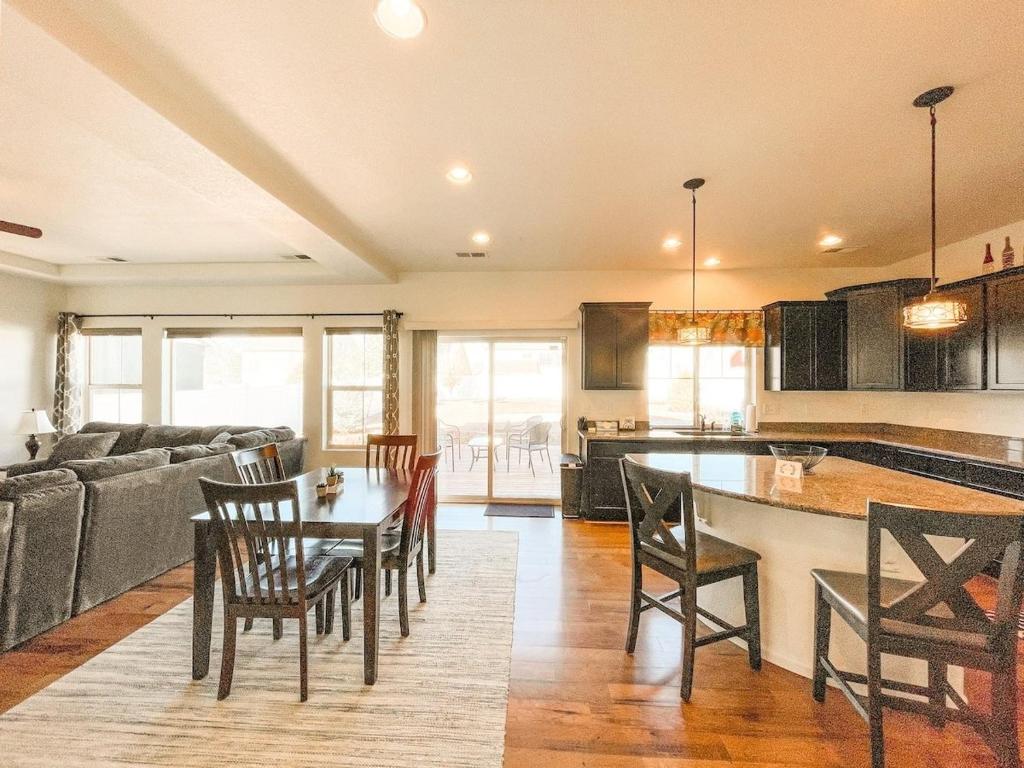 a kitchen and living room with a table and chairs at Spacious Family Getaway 20min to downtown sights in Fountain