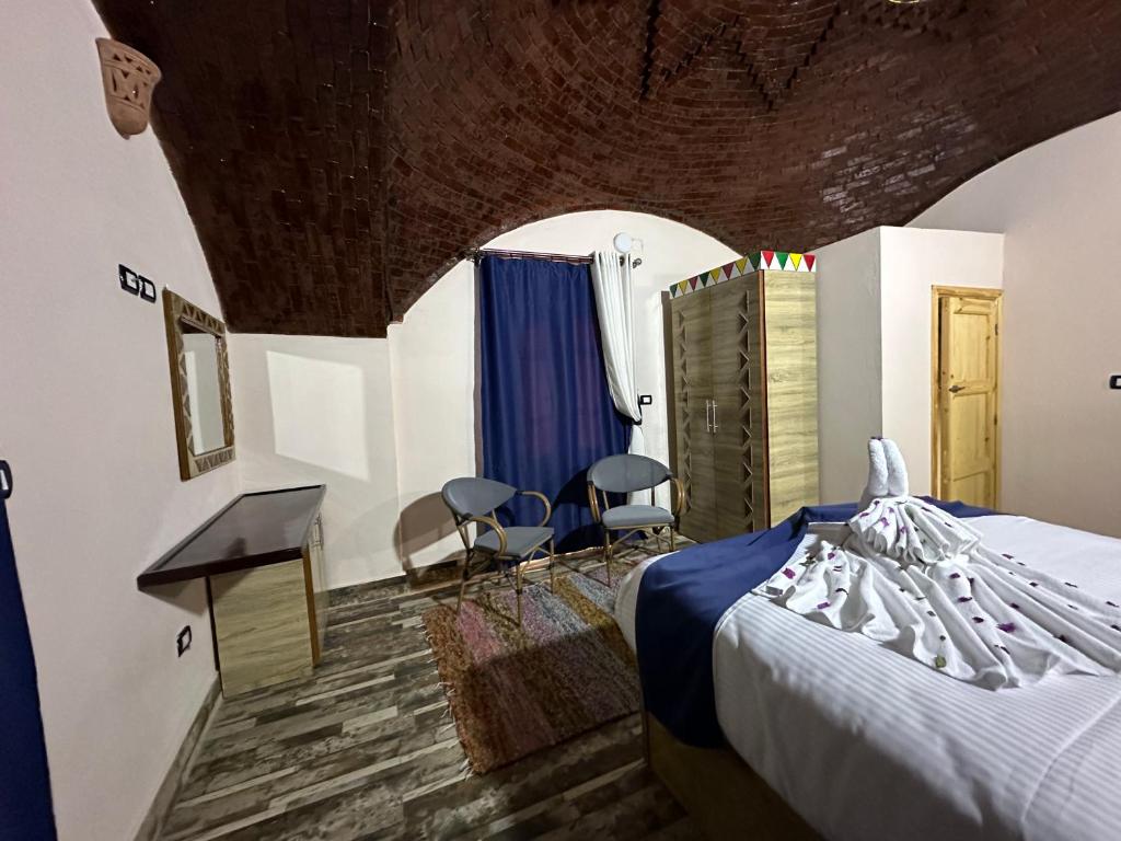 Postel nebo postele na pokoji v ubytování ACHERTOD Nubian House