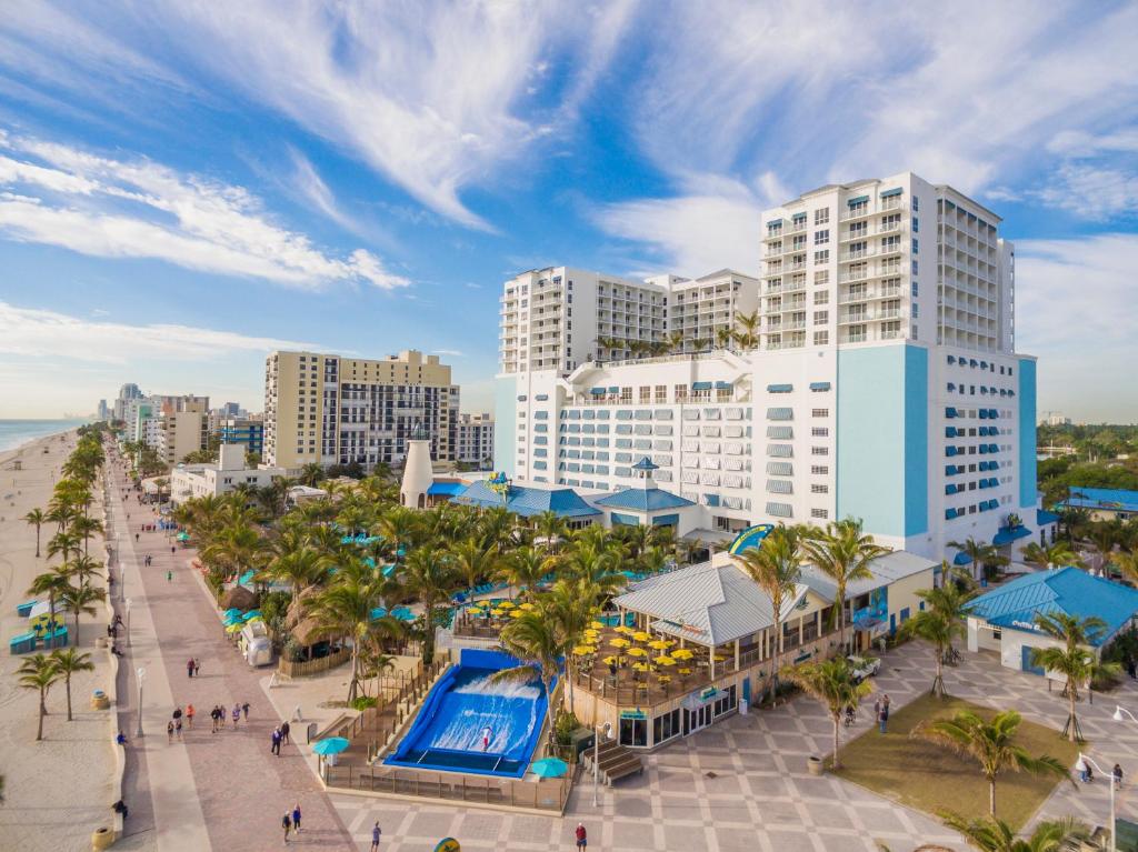 a beach with a lot of palm trees and buildings at Margaritaville Hollywood Beach Resort in Hollywood