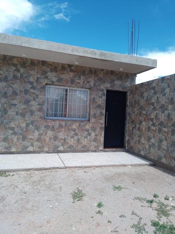 a brick building with a window and a door at Mercedita in Humahuaca