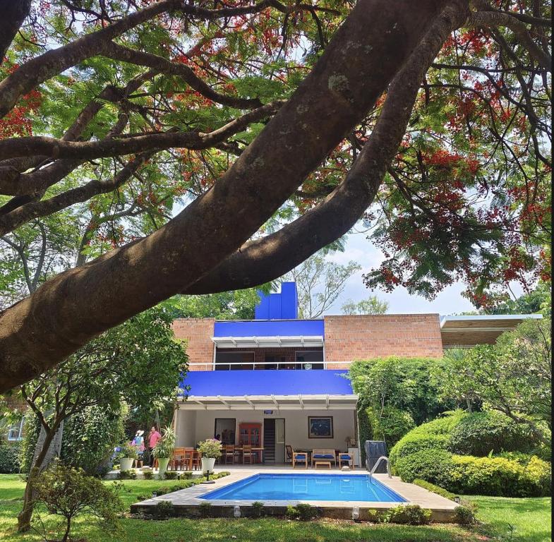 a house with a swimming pool in front of it at Casa María de mi Corazón in Tepoztlán