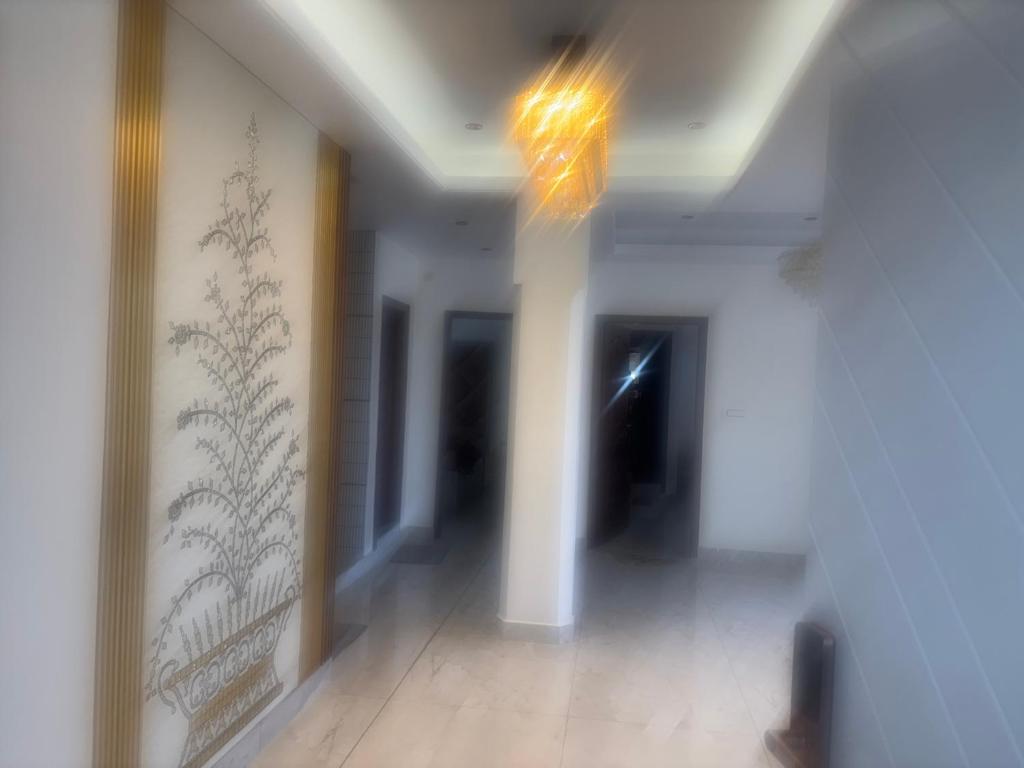 a hallway of a building with white walls and a ceiling at Anayah B and B in Shimla