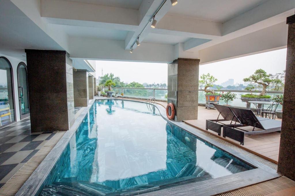 a pool in a hotel with a view of the water at Skyline Tower - Service Apartments in Hanoi