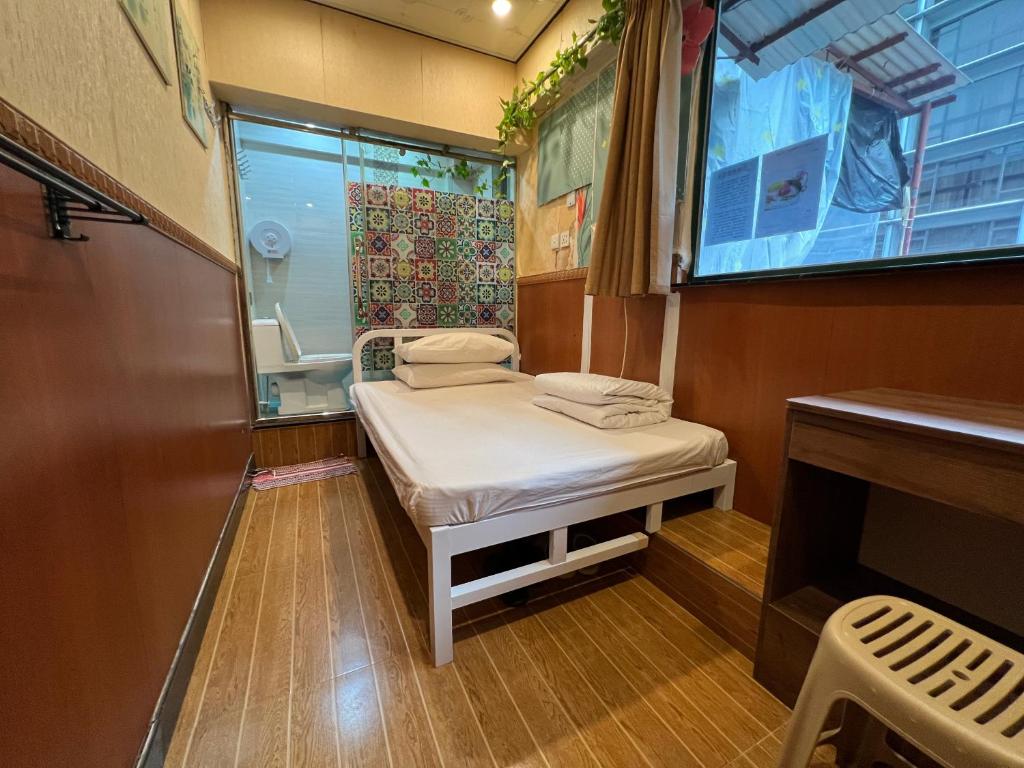 Camera piccola con letto e finestra di 168 Youth Hostel a Hong Kong