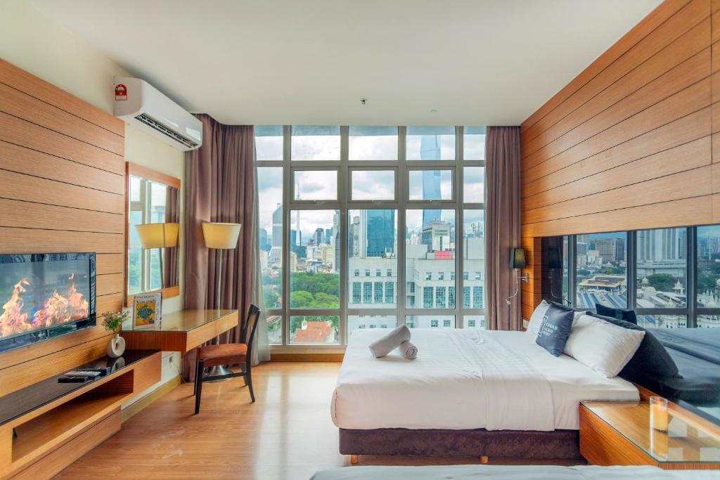 a hotel room with a bed and a large window at Dua Sentral Residence near KL Sentral by COBNB in Kuala Lumpur