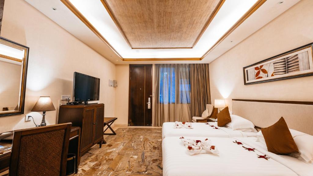 Stony Brook Villa Jianguo Resort Sanya客房内的一张或多张床位