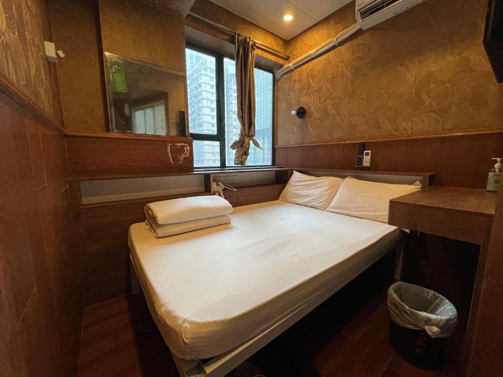 A bed or beds in a room at Just Inn on Nathan Road