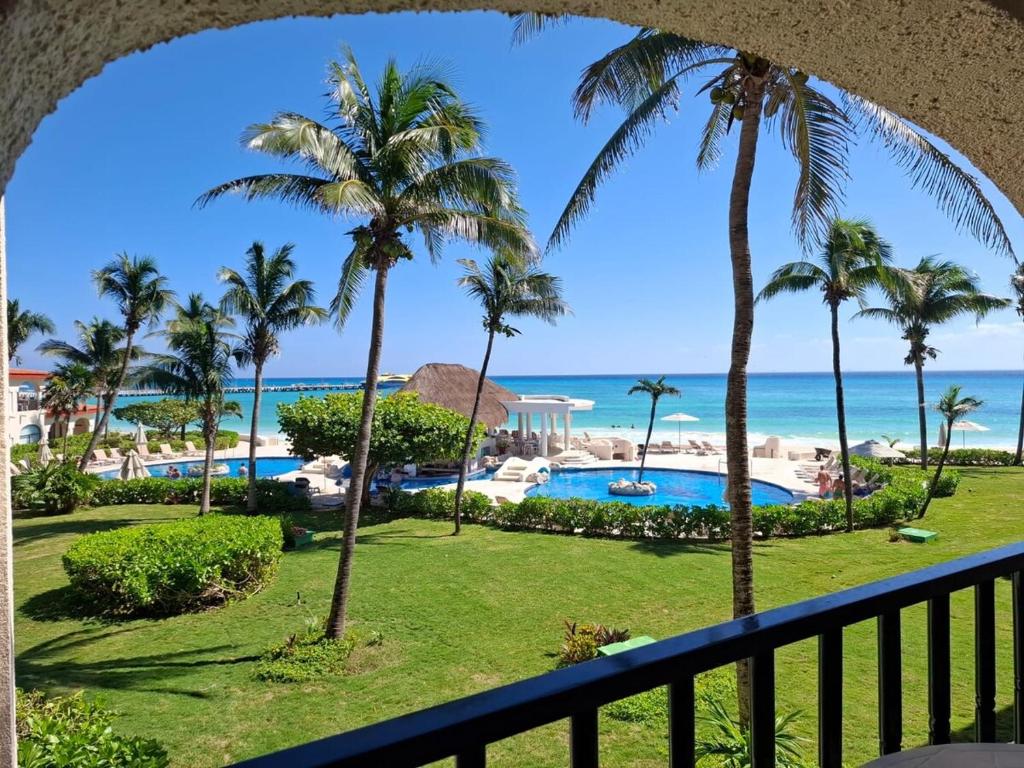 a view of the beach from the balcony of a resort at Condominio Xaman Ha 7107 in Playa del Carmen