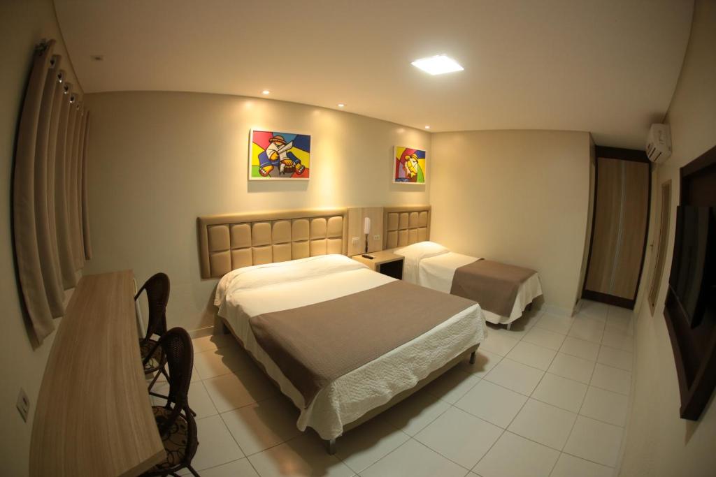 Postel nebo postele na pokoji v ubytování Caruaru Park Hotel
