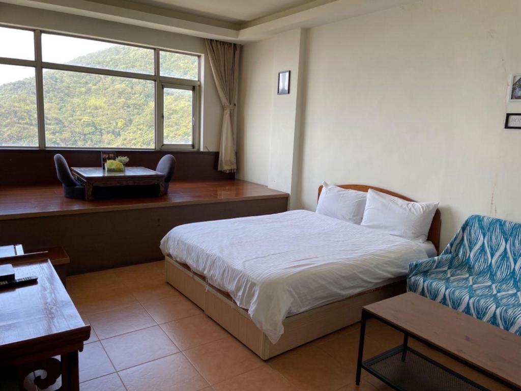 Postel nebo postele na pokoji v ubytování Old Street Seaview Homestay
