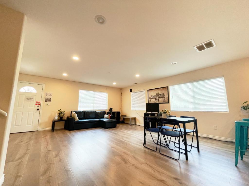 a living room with a couch and a table at The Disney Hostel - Santa Ana in Santa Ana