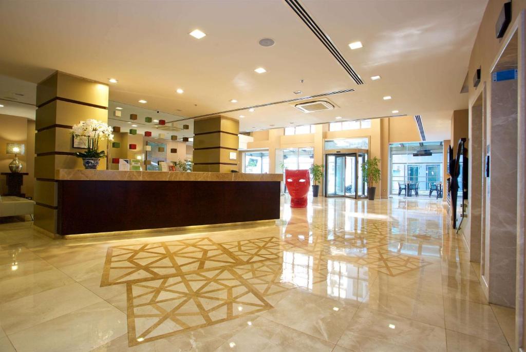a lobby with a reception desk in a building at Ramada By Wyndham İstanbul Taksim in Istanbul