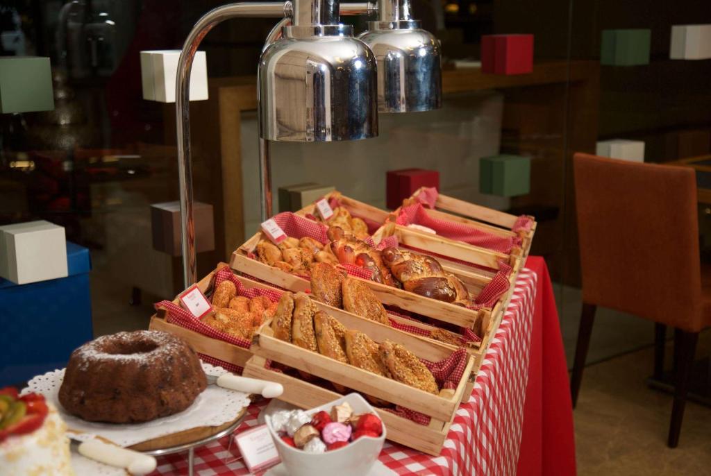 a table topped with a box of pastries on a table at Ramada By Wyndham İstanbul Taksim in Istanbul