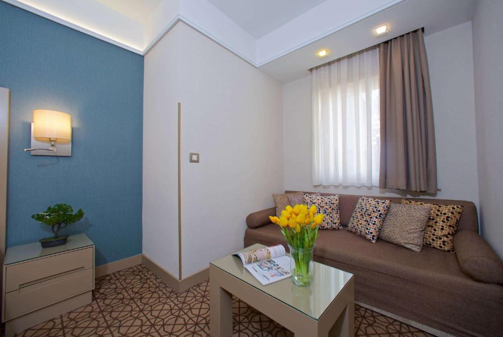 a living room with a couch and a table at Ramada By Wyndham İstanbul Taksim in Istanbul