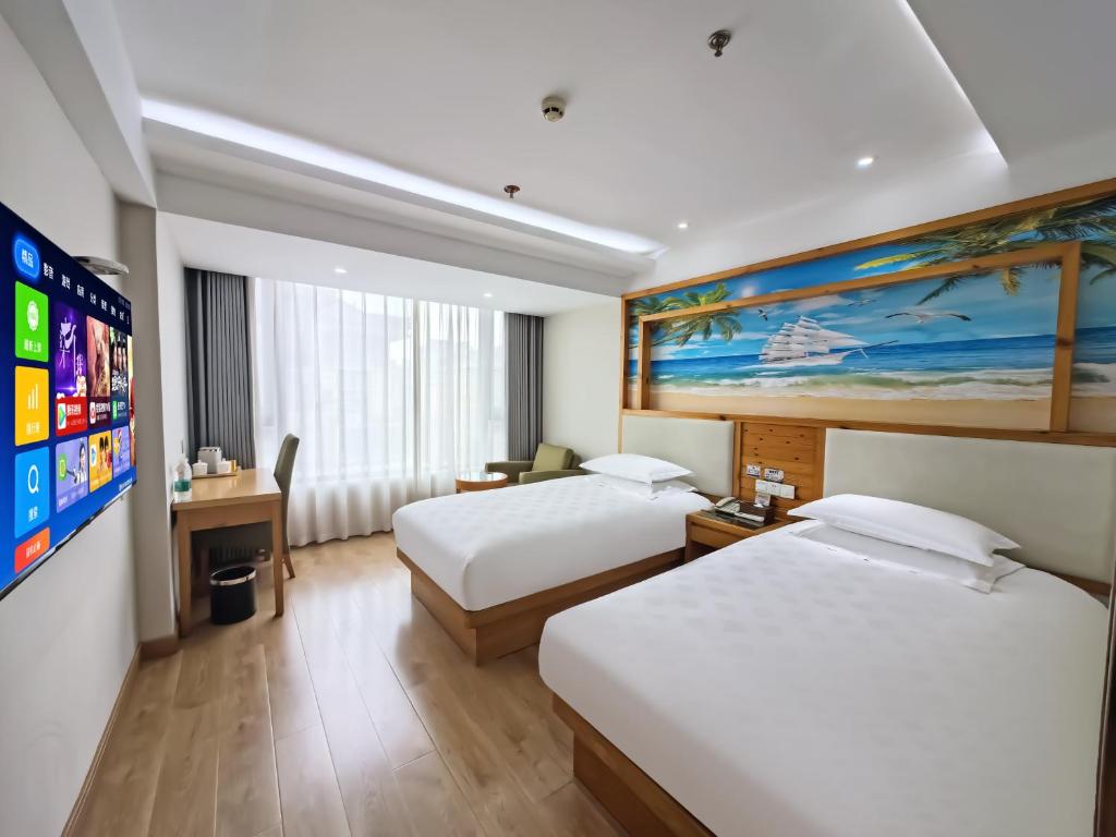 Postel nebo postele na pokoji v ubytování Yiwu Ruifeng Hotel