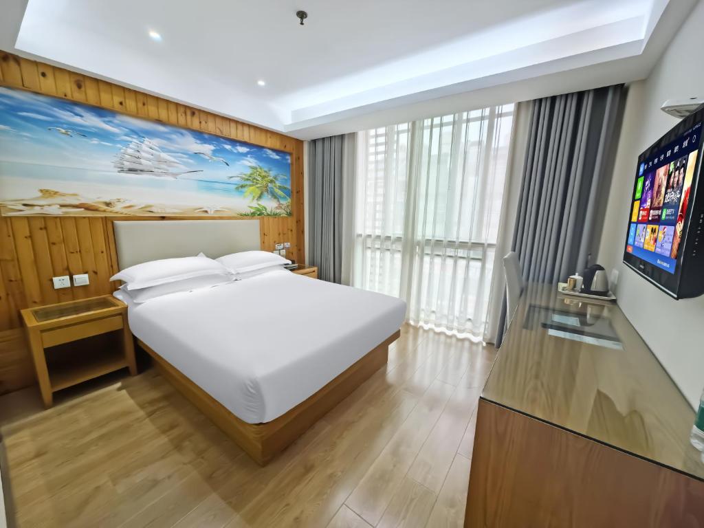 Postel nebo postele na pokoji v ubytování Yiwu Ruifeng Hotel