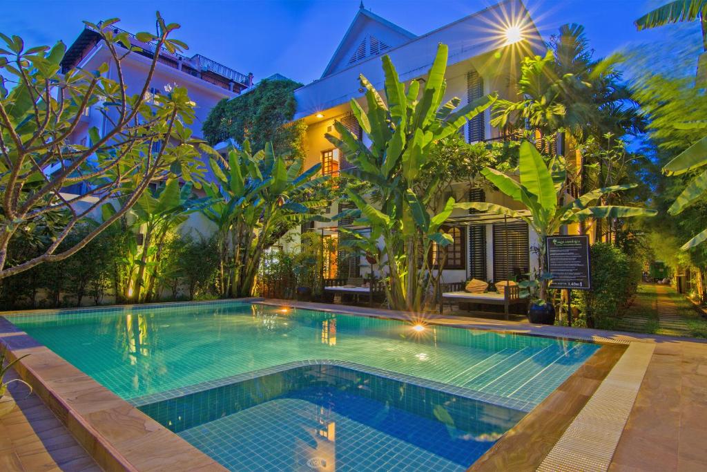 an image of a swimming pool in front of a house at Apsara Centrepole Hotel in Siem Reap