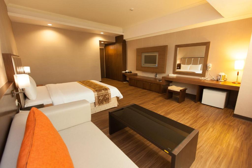 Postel nebo postele na pokoji v ubytování F Hotel - Chiayi