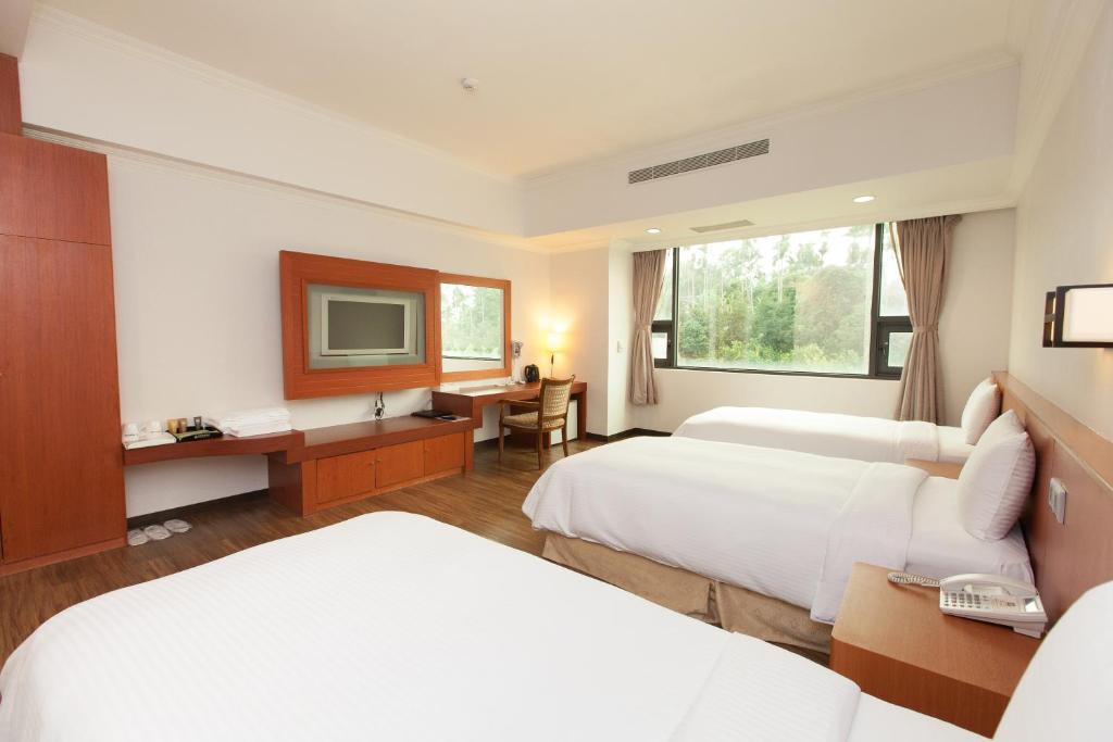 Postel nebo postele na pokoji v ubytování F Hotel - Chiayi