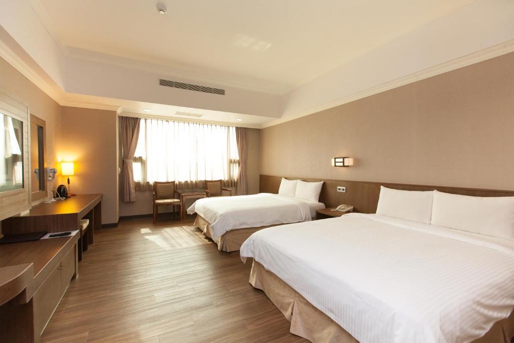 Postel nebo postele na pokoji v ubytování F Hotel - Chiayi