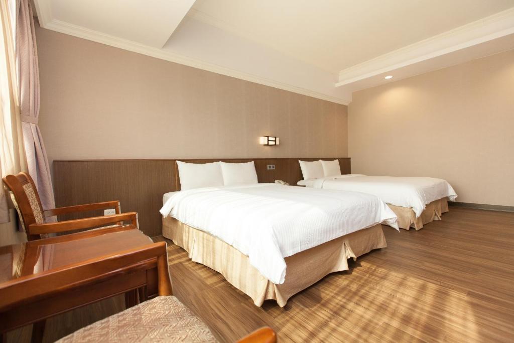 Postel nebo postele na pokoji v ubytování F Hotel - Chiayi
