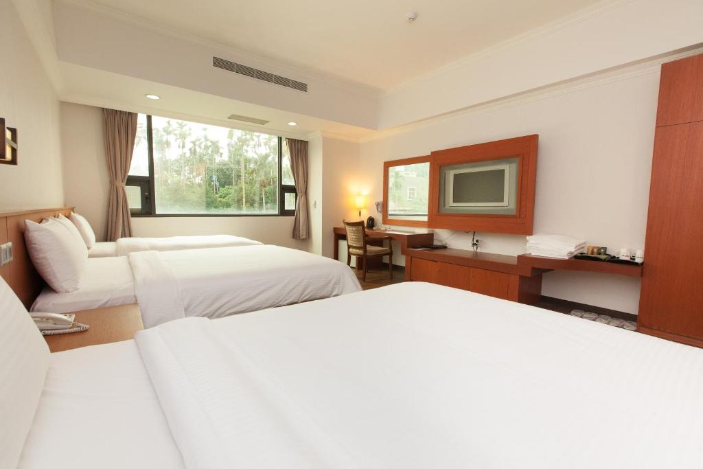 Postel nebo postele na pokoji v ubytování F Hotel - Chiayi