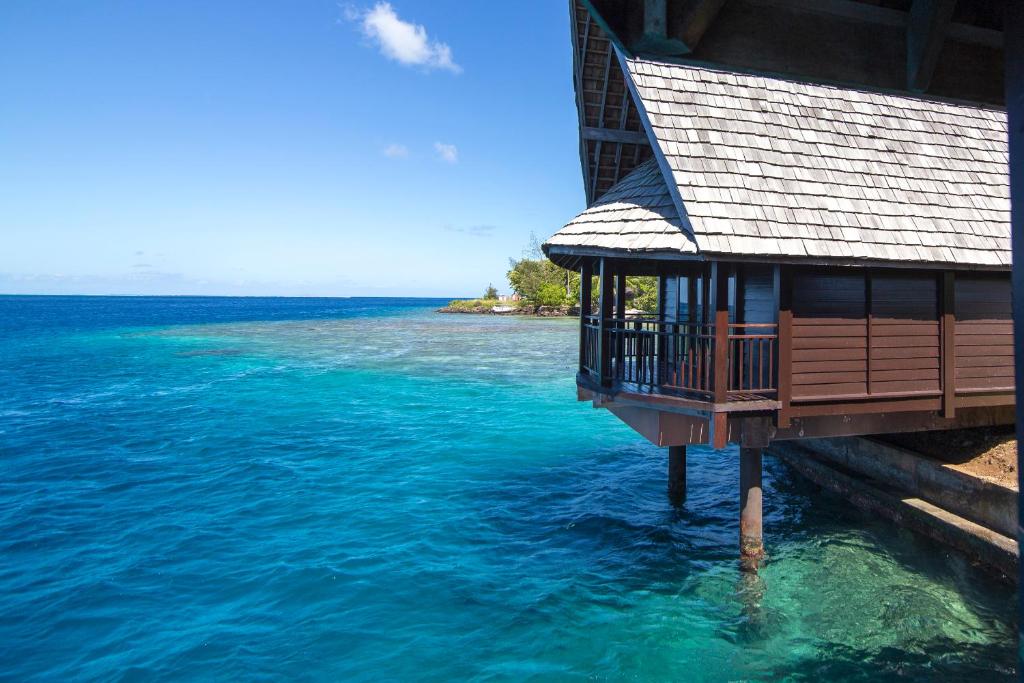 a house in the water next to the ocean at Oa Oa Lodge in Bora Bora