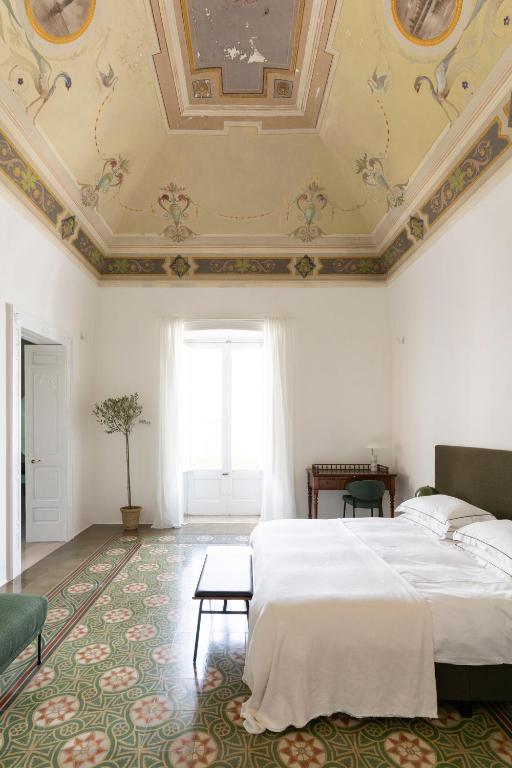Postel nebo postele na pokoji v ubytování Palazzo Piccinno