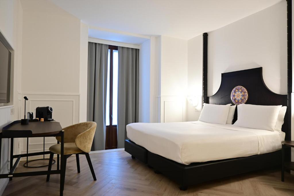 A bed or beds in a room at Palace Catania | UNA Esperienze
