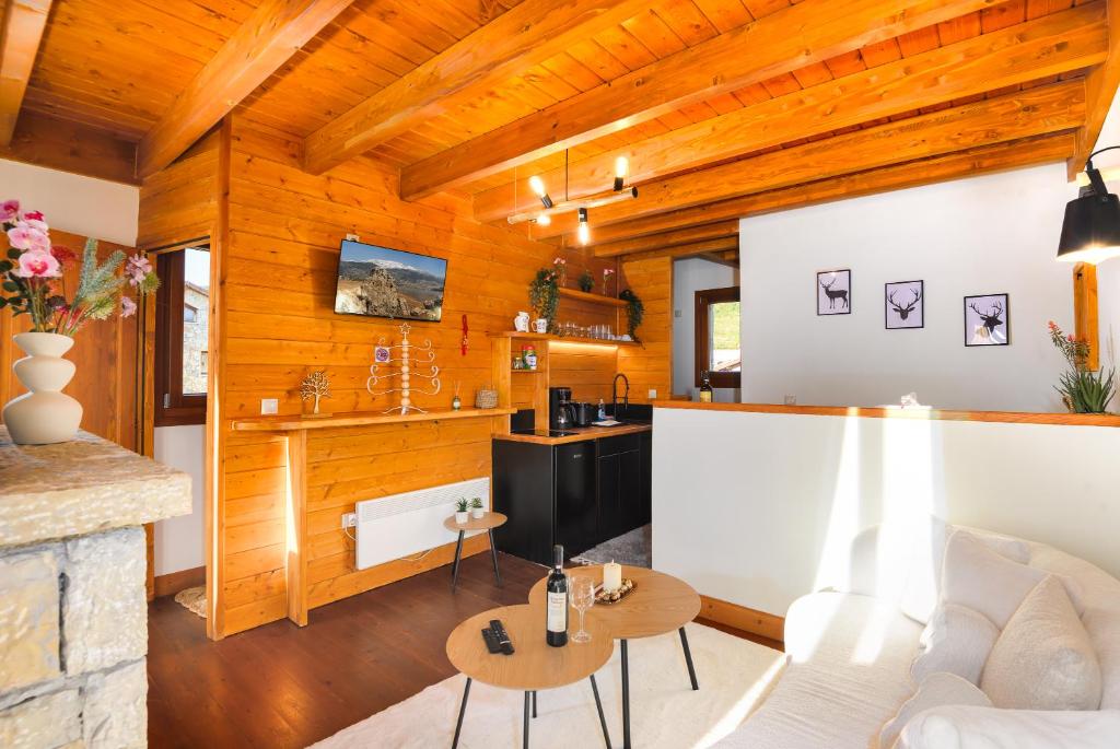 a living room with a white couch and wooden walls at Wishing Stars Luxury Experience Livadi Arachova in Arachova