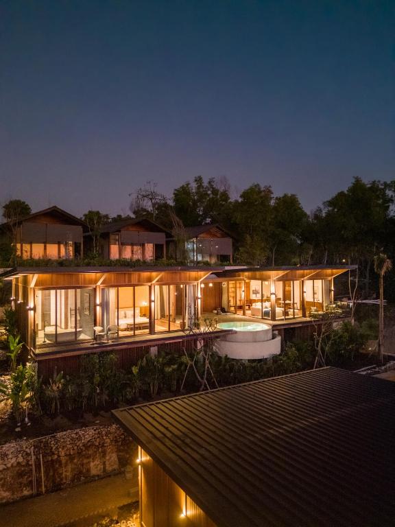 a house with a lot of lights on it at night at Grün Resort Uluwatu in Uluwatu