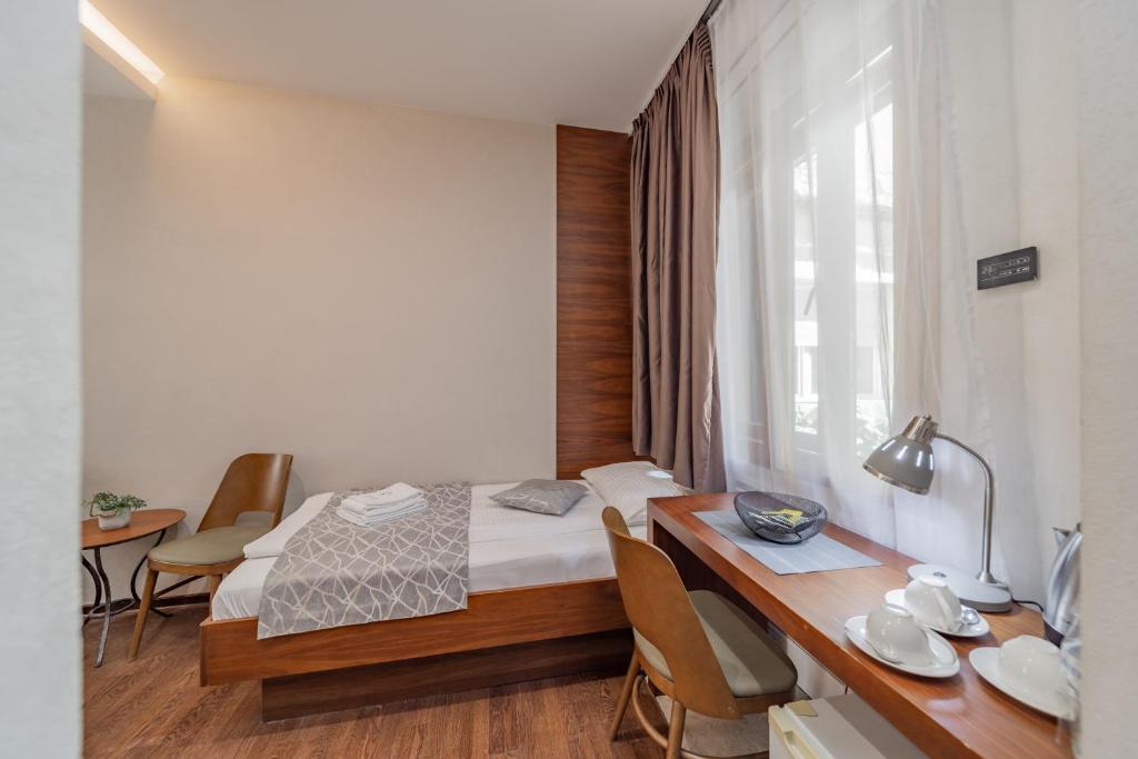 Postel nebo postele na pokoji v ubytování Passpartu Garni hotel Rooms