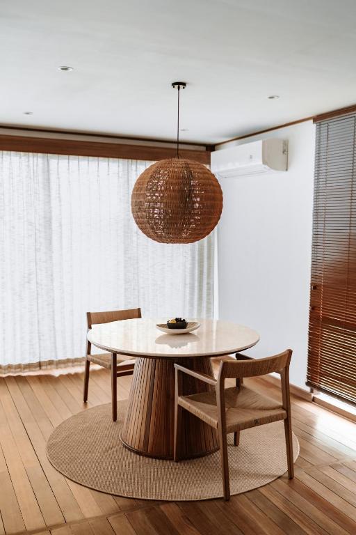 a dining room with a table and two chairs at Grün Resort Uluwatu in Uluwatu