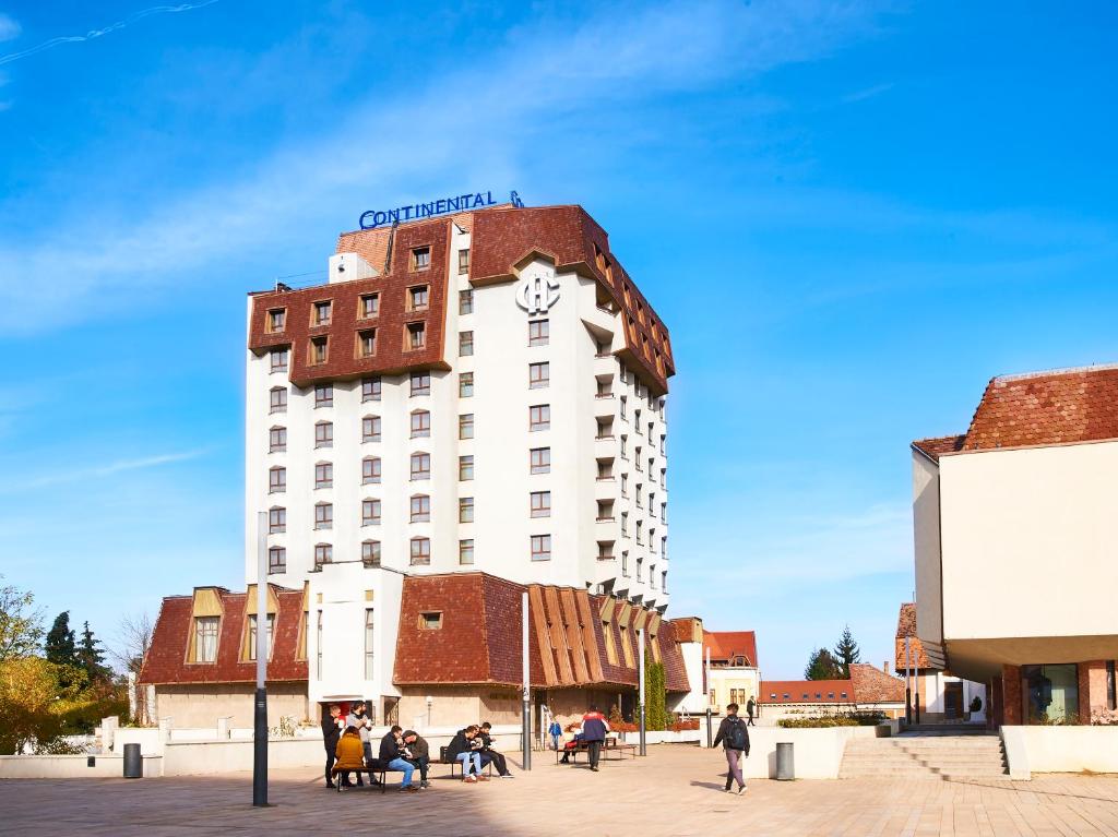 a building with a clock on the top of it at Continental Forum Tirgu Mures in Târgu-Mureş