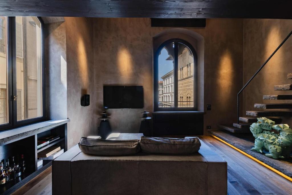 een woonkamer met een grote bank en een raam bij Strozzi Luxury View, RE Apartments Collection in Florence