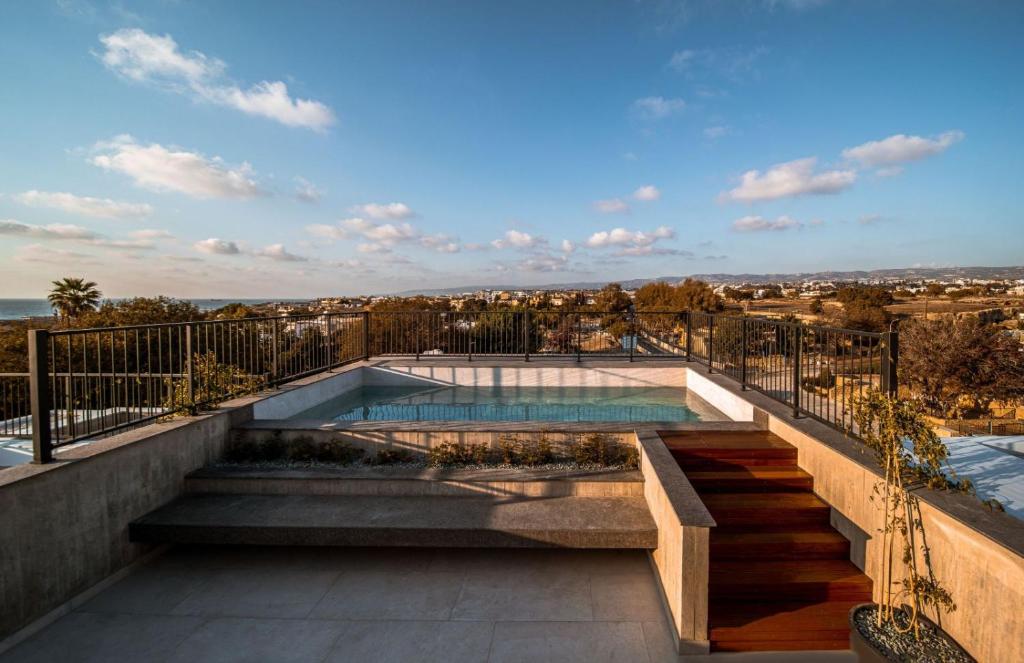 a swimming pool on the roof of a house at Avenue 202 1 BED in Paphos