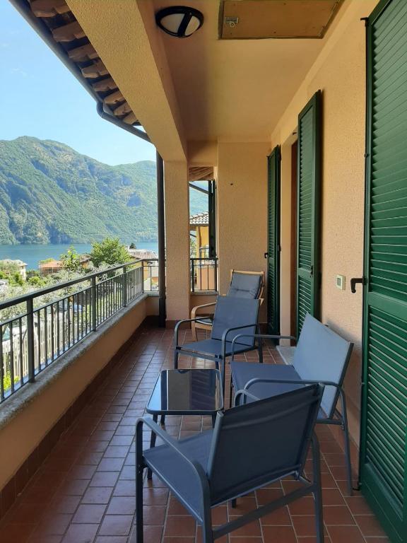 a row of chairs on a balcony with a view at La casa al lago BMOR love&lake in Mezzegra