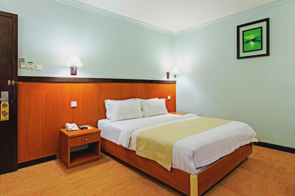 Postel nebo postele na pokoji v ubytování The Orchard Cebu Hotel & Suites powered by Cocotel