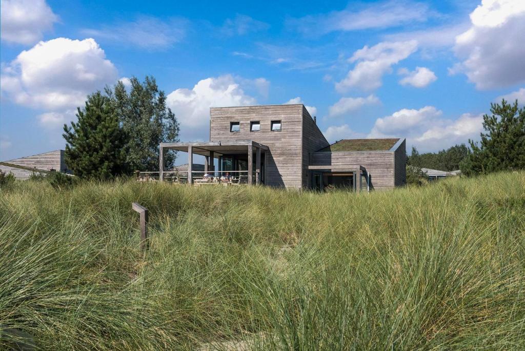 a house on top of a hill in a field at Villa Super VIP | 4 pers. (Villa 68) in Ouddorp
