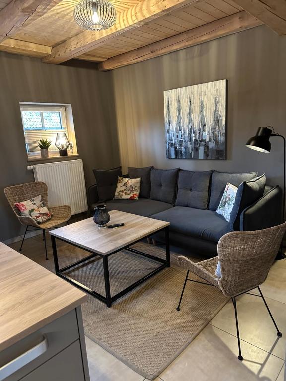 a living room with a couch and a table at Ferienwohnung Bussjans Hof in Dinklage