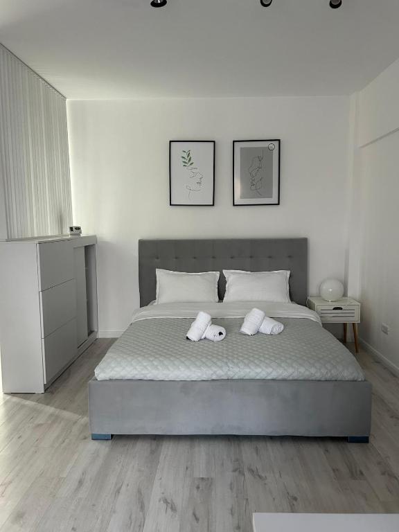 a bedroom with a bed with two towels on it at Best Value Studio Primavara, Free Parking in Bucharest
