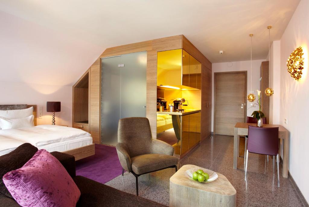 a hotel room with a bed and a desk at abito Suites in Leipzig