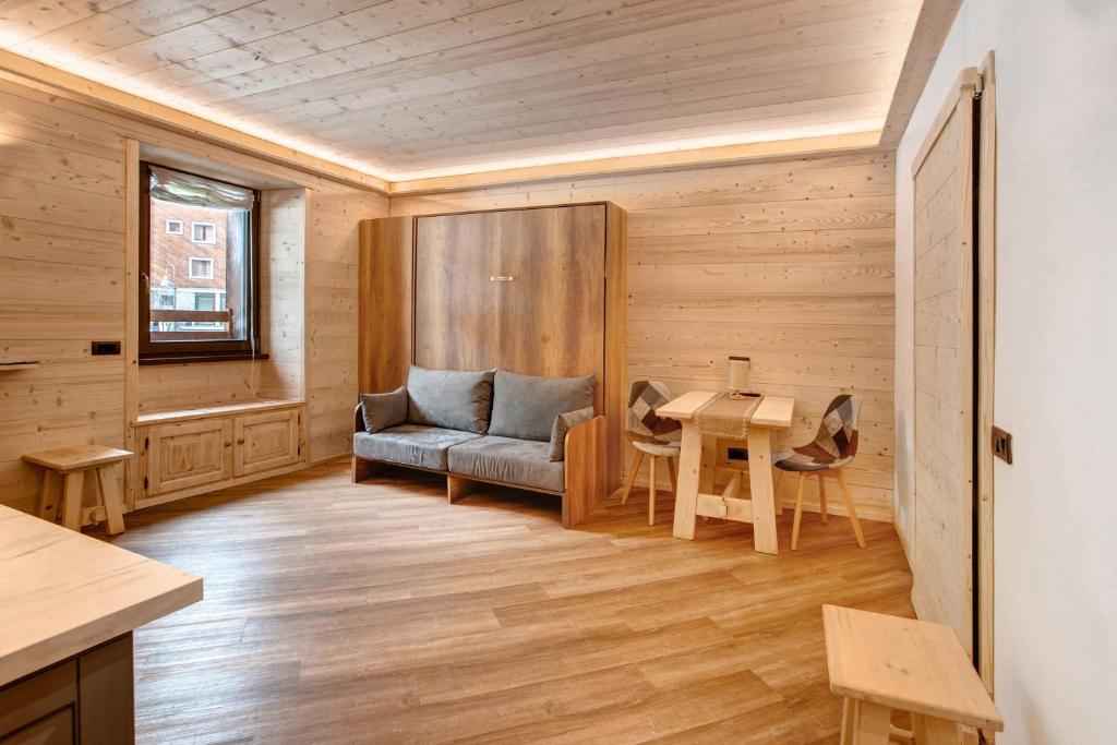 a living room with a couch and a table at Appartamento Centro Santa Caterina in Santa Caterina Valfurva