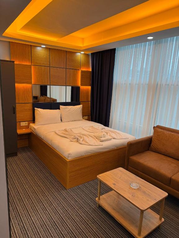 a hotel room with a bed and a couch at Premium Palace in Istanbul