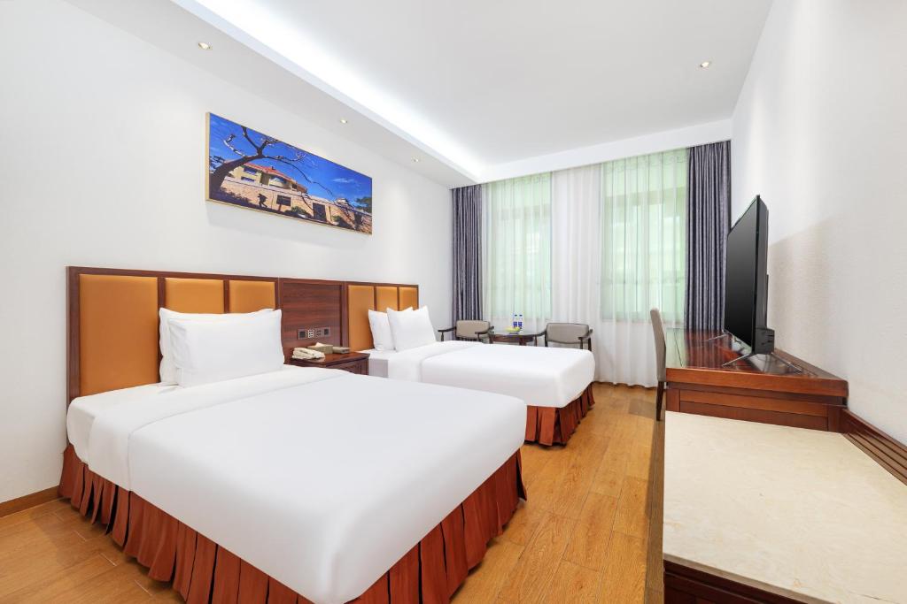 Postel nebo postele na pokoji v ubytování Xiamen Kulangsu Resort Hotel
